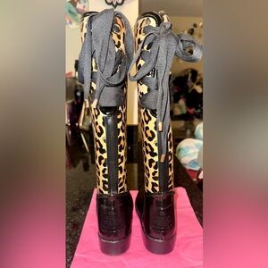 Coach Tristee rubber rain boots with a leopard print pattern and tie-up laces
